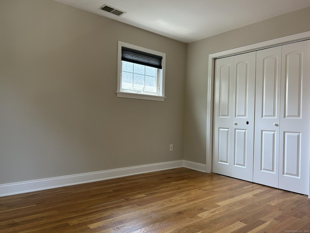 756 Hart St, Bridgeport, CT 06606 - unfurnished bedroom featuring wood finished floors and a closet