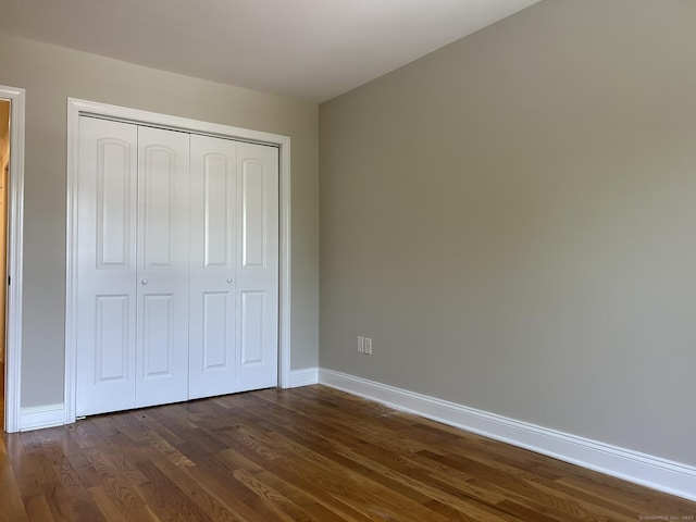 756 Hart St, Bridgeport, CT 06606 - unfurnished bedroom with dark wood-style floors and a closet