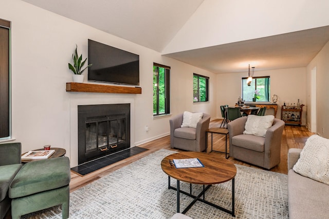 11 Wood Duck Ln Unit 11, Simsbury, CT 06081 - living area featuring wood finished floors, a glass covered fireplace, and lofted ceiling