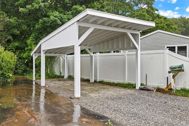 8 Edwards Rd, Old Saybrook, CT 06475 - view of patio with a detached carport, gravel driveway, and a water view