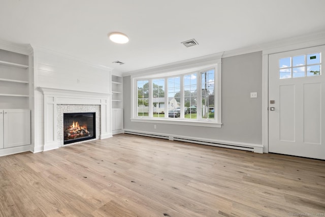 8 Edwards Rd, Old Saybrook, CT 06475 - unfurnished living room featuring ornamental molding, a baseboard heating unit, light wood-type flooring, built in shelves, and a glass covered fireplace