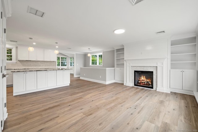 8 Edwards Rd, Old Saybrook, CT 06475 - unfurnished living room with light wood-style floors, crown molding, a lit fireplace, and recessed lighting