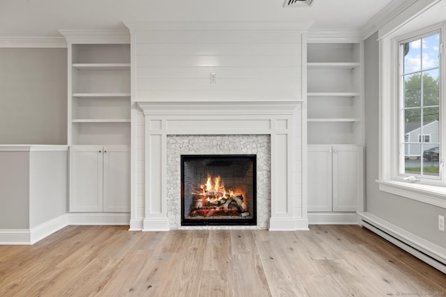 8 Edwards Rd, Old Saybrook, CT 06475 - unfurnished living room with a baseboard heating unit, wood finished floors, crown molding, a warm lit fireplace, and built in features
