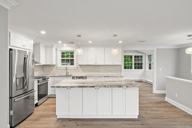 8 Edwards Rd, Old Saybrook, CT 06475 - kitchen featuring appliances with stainless steel finishes, white cabinetry, decorative backsplash, light stone counters, and recessed lighting