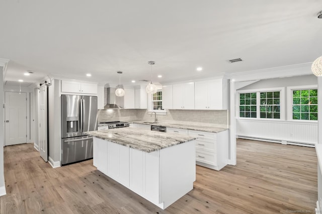 8 Edwards Rd, Old Saybrook, CT 06475 - kitchen with appliances with stainless steel finishes, wall chimney exhaust hood, a baseboard heating unit, decorative backsplash, and recessed lighting