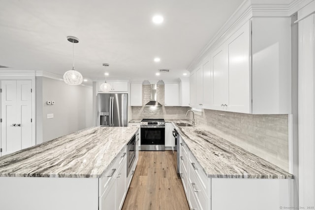 8 Edwards Rd, Old Saybrook, CT 06475 - kitchen featuring stainless steel appliances, wall chimney exhaust hood, white cabinetry, recessed lighting, and a center island
