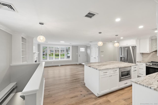 8 Edwards Rd, Old Saybrook, CT 06475 - kitchen with stainless steel appliances, a baseboard radiator, decorative backsplash, white cabinets, and recessed lighting