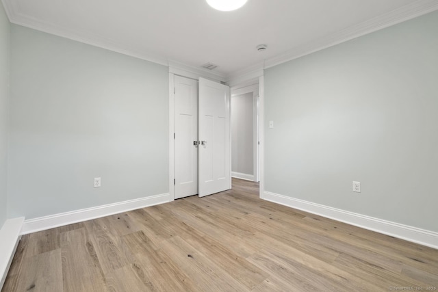 8 Edwards Rd, Old Saybrook, CT 06475 - unfurnished bedroom with ornamental molding, light wood-type flooring, and a closet