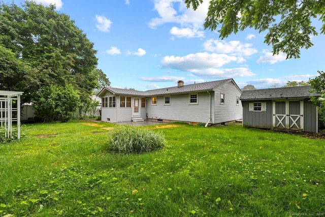 8 Edwards Rd, Old Saybrook, CT 06475 - back of property with a storage shed, a lawn, entry steps, a chimney, and a patio