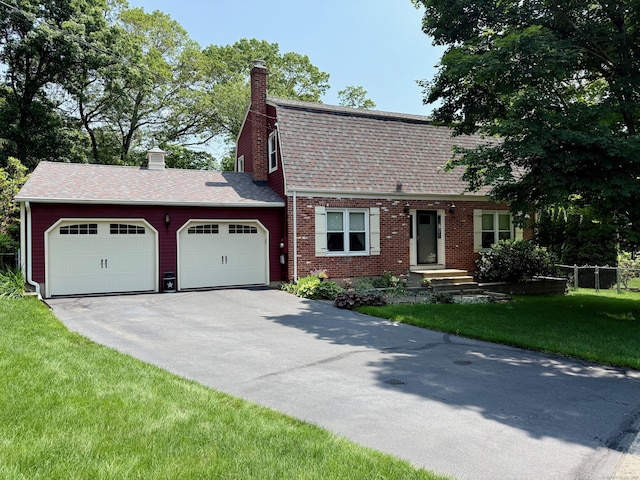 81 Jan Rd, Bristol, CT 06010 - colonial inspired home with an attached garage, driveway, a chimney, a shingled roof, and brick siding
