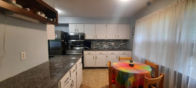 75 Hunter Ct Unit 75, Torrington, CT 06790 - kitchen with appliances with stainless steel finishes, tasteful backsplash, white cabinetry, and dark stone counters