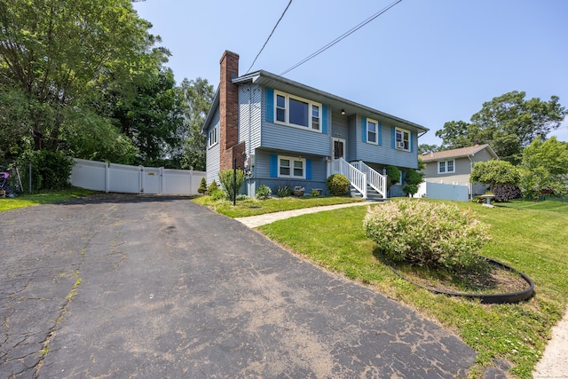 30 S Dale St, East Haven, CT 06513 - bi-level home featuring a chimney, asphalt driveway, and a gate