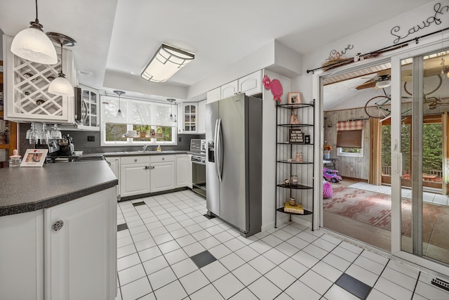 30 S Dale St, East Haven, CT 06513 - kitchen featuring stainless steel appliances, dark countertops, healthy amount of natural light, and white cabinetry