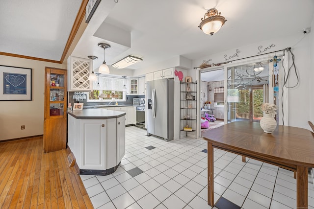 30 S Dale St, East Haven, CT 06513 - kitchen featuring stainless steel refrigerator with ice dispenser, a peninsula, dark countertops, white cabinets, and glass insert cabinets