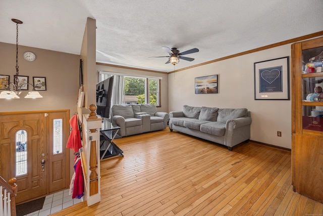 30 S Dale St, East Haven, CT 06513 - living area with a chandelier, ceiling fan, light wood finished floors, crown molding, and a textured ceiling