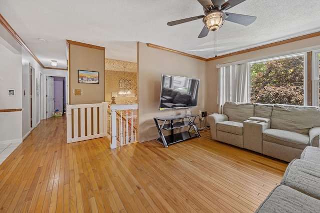 30 S Dale St, East Haven, CT 06513 - living room featuring light wood-type flooring, ornamental molding, ceiling fan, and a textured ceiling
