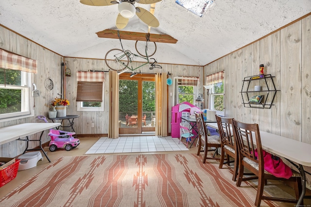 30 S Dale St, East Haven, CT 06513 - dining space with vaulted ceiling, plenty of natural light, a textured ceiling, a ceiling fan, and wood walls
