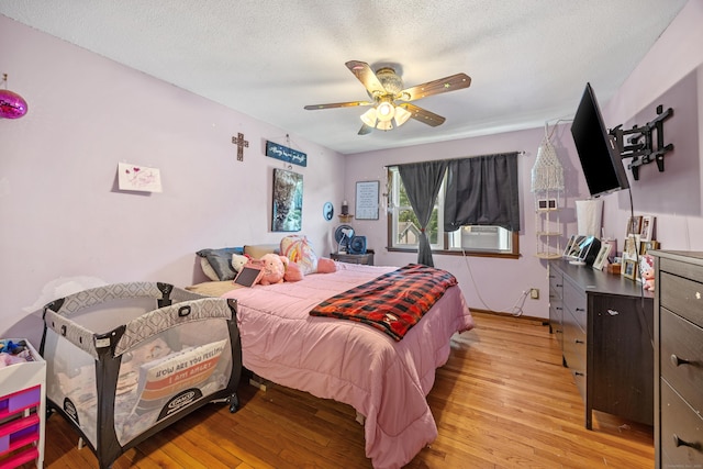 30 S Dale St, East Haven, CT 06513 - bedroom with light wood finished floors, a textured ceiling, ceiling fan, and cooling unit