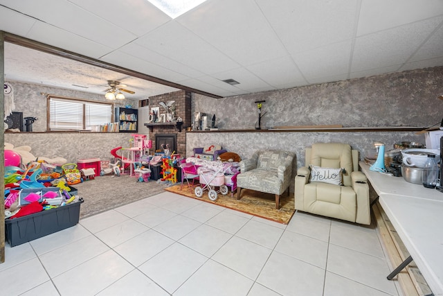 30 S Dale St, East Haven, CT 06513 - playroom with a paneled ceiling, ceiling fan, tile patterned floors, and a brick fireplace