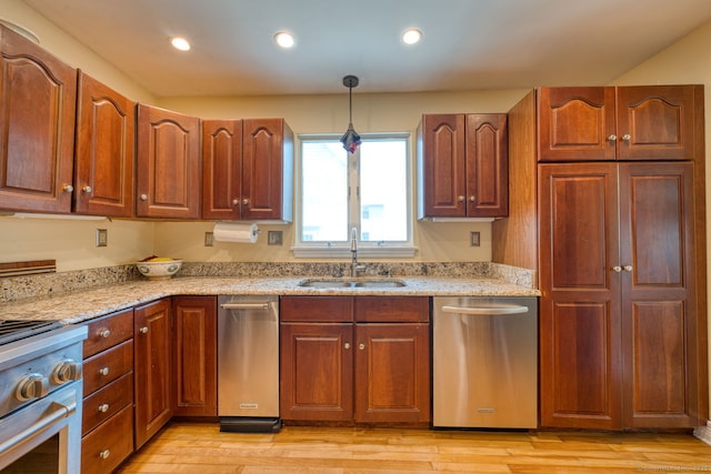 7 Crescent Ave, East Lyme, CT 06357 - kitchen featuring a sink, stainless steel appliances, hanging light fixtures, light stone counters, and light wood-style flooring