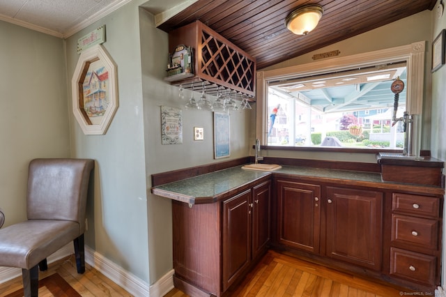 7 Crescent Ave, East Lyme, CT 06357 - bar featuring a sink, light wood-type flooring, ornamental molding, and lofted ceiling