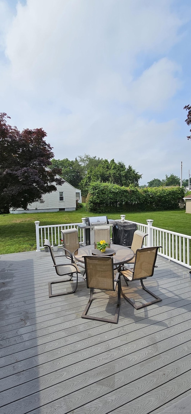 258 Eddy Glover Blvd, New Britain, CT 06053 - deck with outdoor dining area, a yard, and a grill