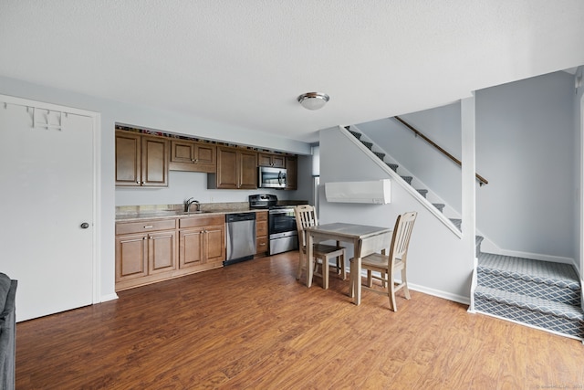 22 River Colony, Guilford, CT 06437 - kitchen featuring stainless steel appliances, dark wood-style flooring, light countertops, and a textured ceiling