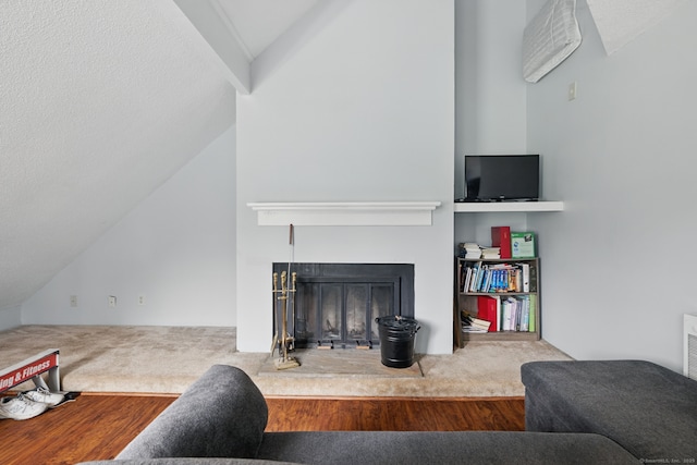 22 River Colony, Guilford, CT 06437 - living area with a fireplace with raised hearth, vaulted ceiling, and carpet floors