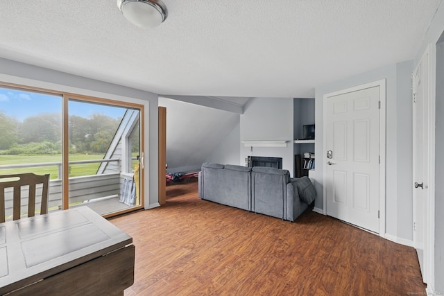 22 River Colony, Guilford, CT 06437 - living room featuring wood finished floors, a textured ceiling, and a fireplace
