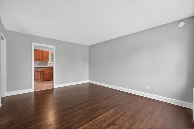 6 Crescent Dr, Danbury, CT 06810 - unfurnished living room featuring baseboards and dark wood-style floors
