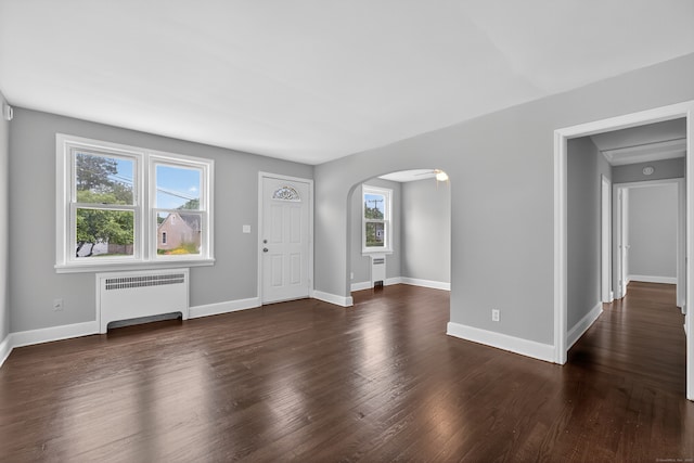 6 Crescent Dr, Danbury, CT 06810 - entryway with radiator heating unit, arched walkways, and dark wood finished floors