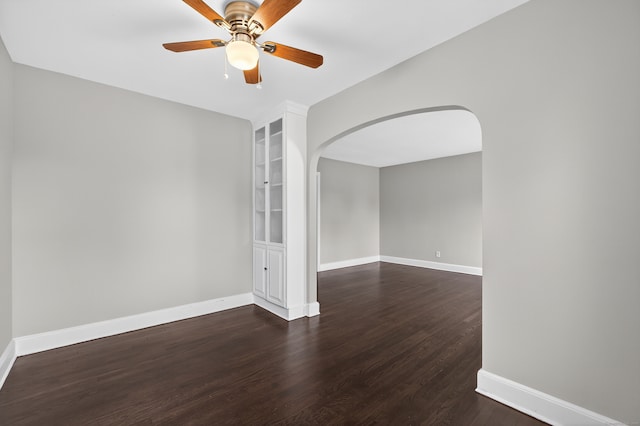 6 Crescent Dr, Danbury, CT 06810 - spare room with arched walkways, ceiling fan, and dark wood-type flooring