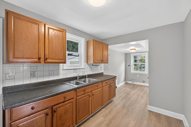 6 Crescent Dr, Danbury, CT 06810 - kitchen featuring light wood finished floors, decorative backsplash, dark countertops, and brown cabinets