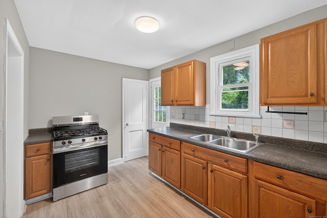 6 Crescent Dr, Danbury, CT 06810 - kitchen with stainless steel gas range, dark countertops, and light wood-style flooring
