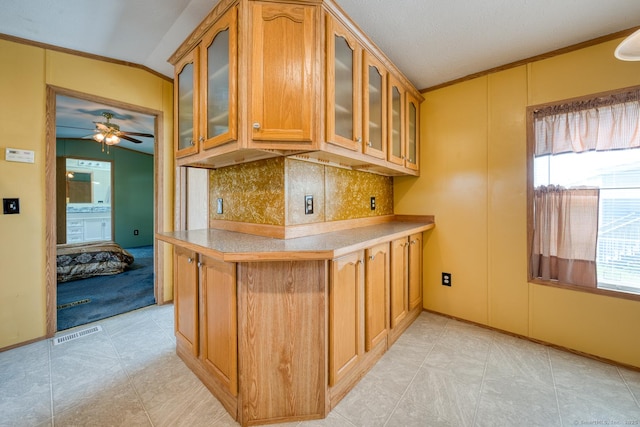 60 Lions Way, Windham, CT 06256 - kitchen featuring glass insert cabinets, decorative backsplash, a ceiling fan, brown cabinets, and vaulted ceiling