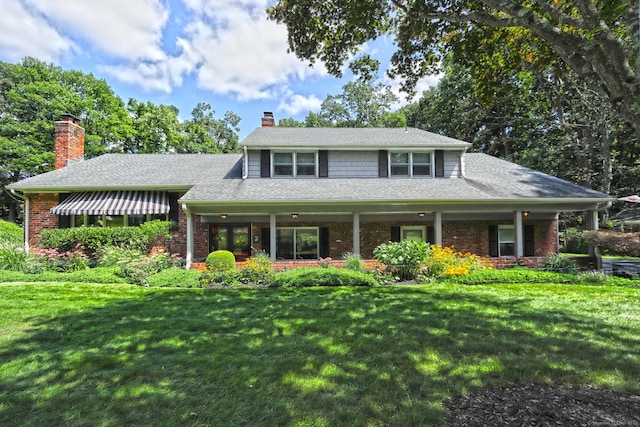811 Indian Hill Rd, Orange, CT 06477 - view of front of property featuring a front lawn, brick siding, a chimney, and roof with shingles