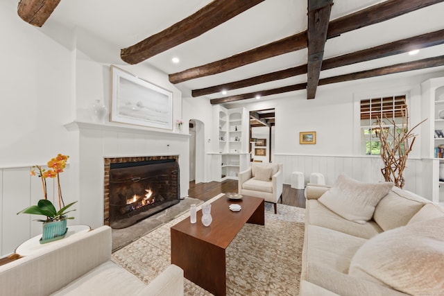 47 Godfrey Rd W, Weston, CT 06883 - living room with a tile fireplace, a wainscoted wall, wood finished floors, beam ceiling, and recessed lighting