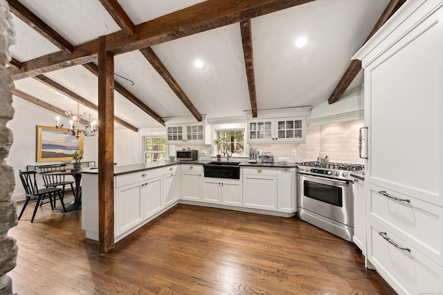 47 Godfrey Rd W, Weston, CT 06883 - kitchen featuring stainless steel appliances, glass insert cabinets, a chandelier, dark countertops, and decorative backsplash