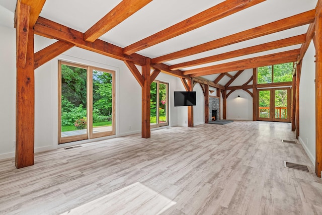 122 Old Post Rd, Old Saybrook, CT 06475 - unfurnished living room with a warm lit fireplace and light wood-style floors
