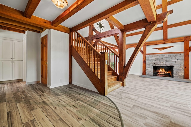 122 Old Post Rd, Old Saybrook, CT 06475 - stairs with beamed ceiling, wood finished floors, and a fireplace