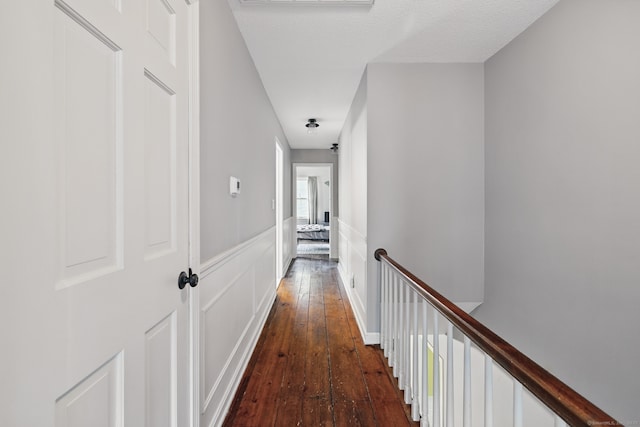 65 Nassahegan Dr, Burlington, CT 06013 - hallway with hardwood / wood-style flooring, an upstairs landing, a decorative wall, and a wainscoted wall
