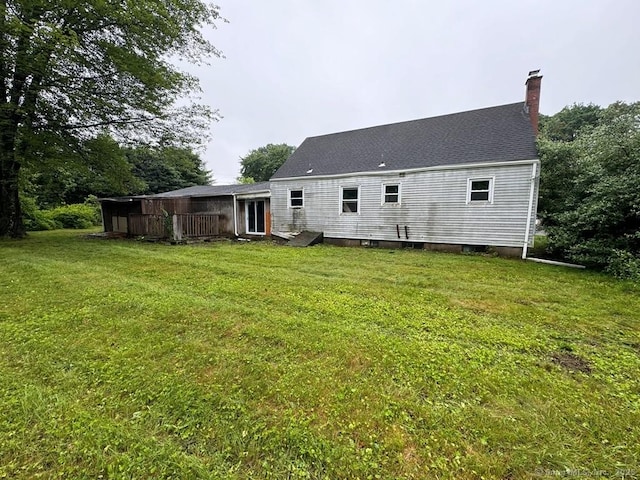 4 Lox Ln, Enfield, CT 06082 - back of property featuring a chimney, a yard, and roof with shingles