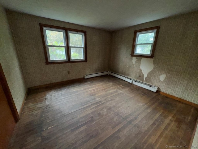 4 Lox Ln, Enfield, CT 06082 - spare room with wood finished floors, wallpapered walls, and a baseboard heating unit