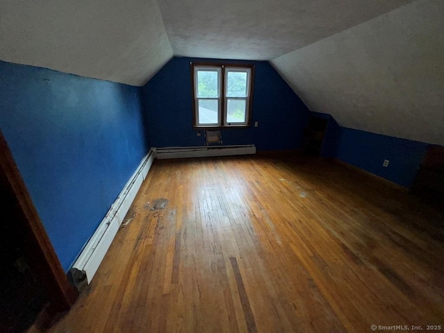 4 Lox Ln, Enfield, CT 06082 - additional living space featuring a baseboard radiator, hardwood / wood-style floors, and vaulted ceiling