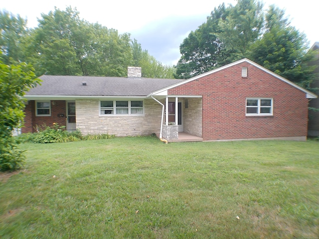 152 Old Mill Rd, Middletown, CT 06457 - rear view of house with a chimney, a lawn, and stone siding