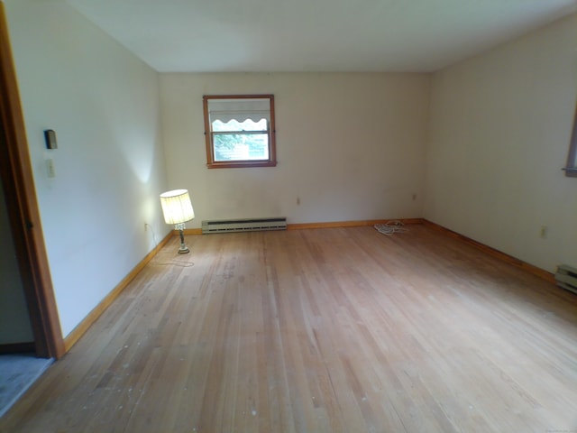 152 Old Mill Rd, Middletown, CT 06457 - spare room featuring a baseboard heating unit and wood-type flooring