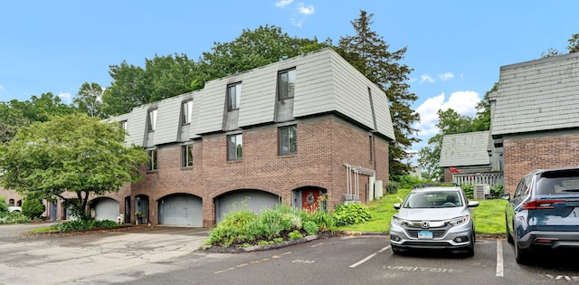 70 Trolley Crossing Ln Unit 70, Middletown, CT 06457 - view of front of home featuring uncovered parking and brick siding