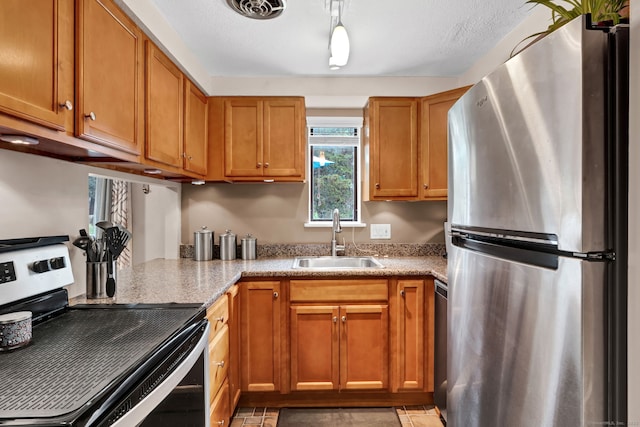 70 Trolley Crossing Ln Unit 70, Middletown, CT 06457 - kitchen with stainless steel appliances, brown cabinets, and light stone countertops