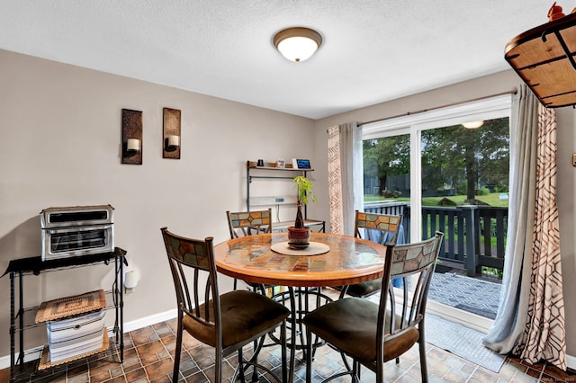 70 Trolley Crossing Ln Unit 70, Middletown, CT 06457 - dining room featuring a textured ceiling and stone finish flooring