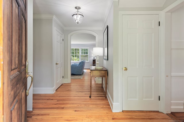 37 Woodridge Cir, New Canaan, CT 06840 - foyer entrance featuring light wood-style flooring, ornamental molding, and arched walkways